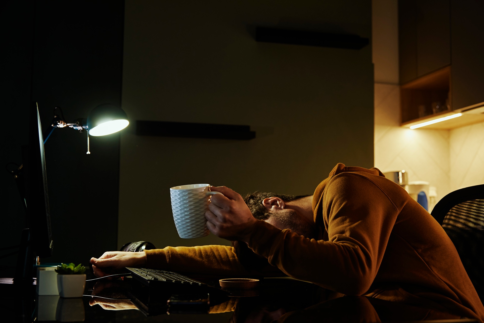 Tired man sleeping at workplace